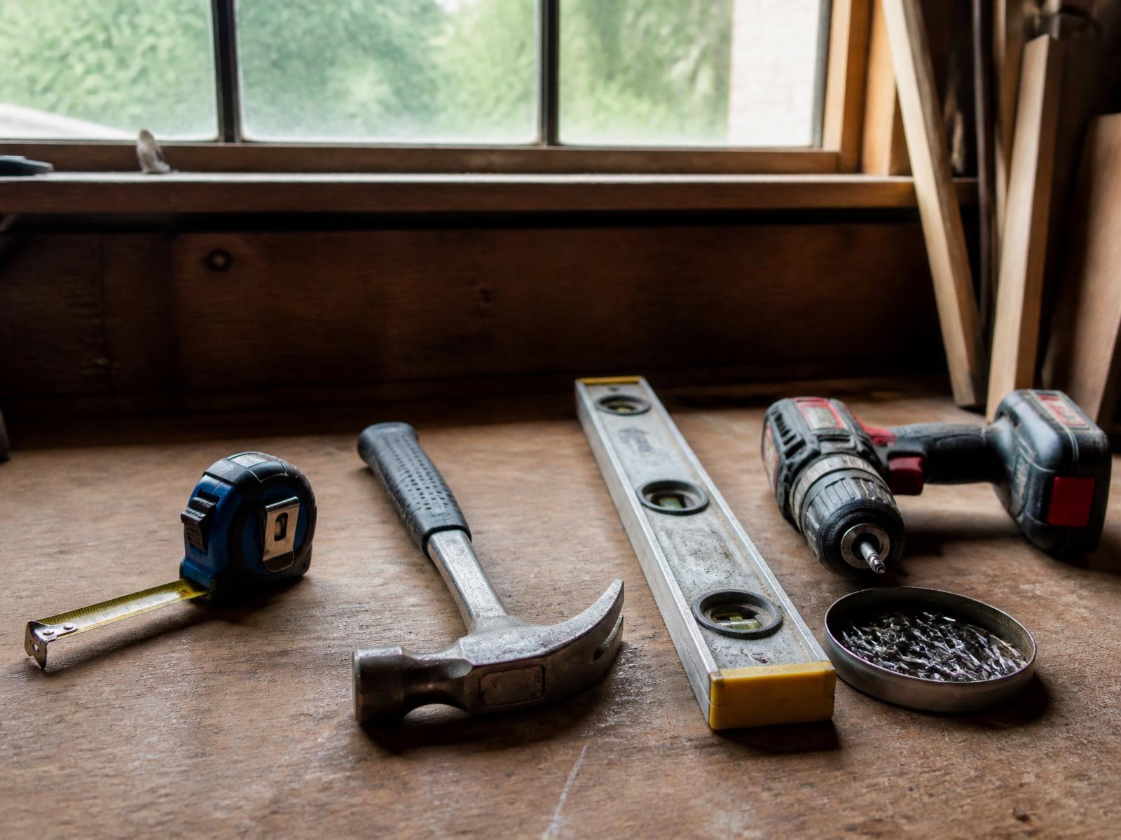 Construction tools neatly arranged on a wooden workbench
